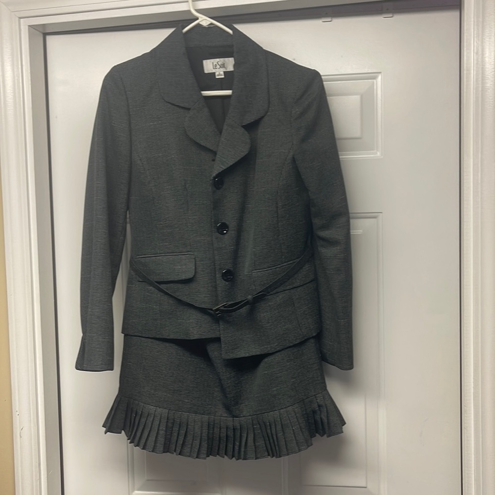 Stylish suit with pleat detail and belt around blazer
